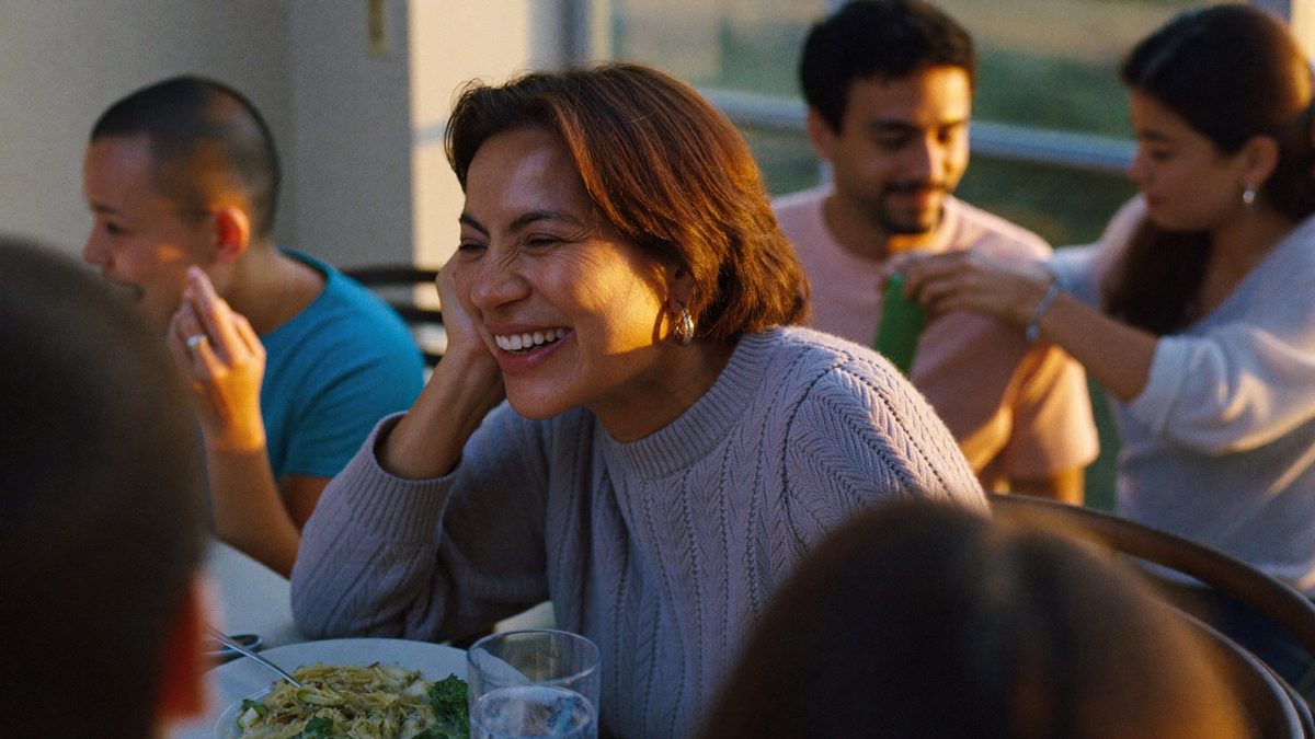 Family laughing together at the dinner table