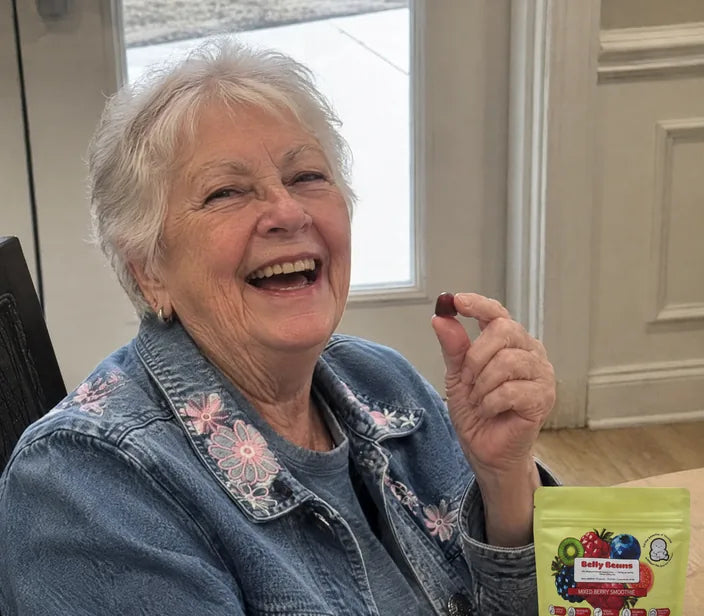 Woman laughing with a Belly Beans gummy