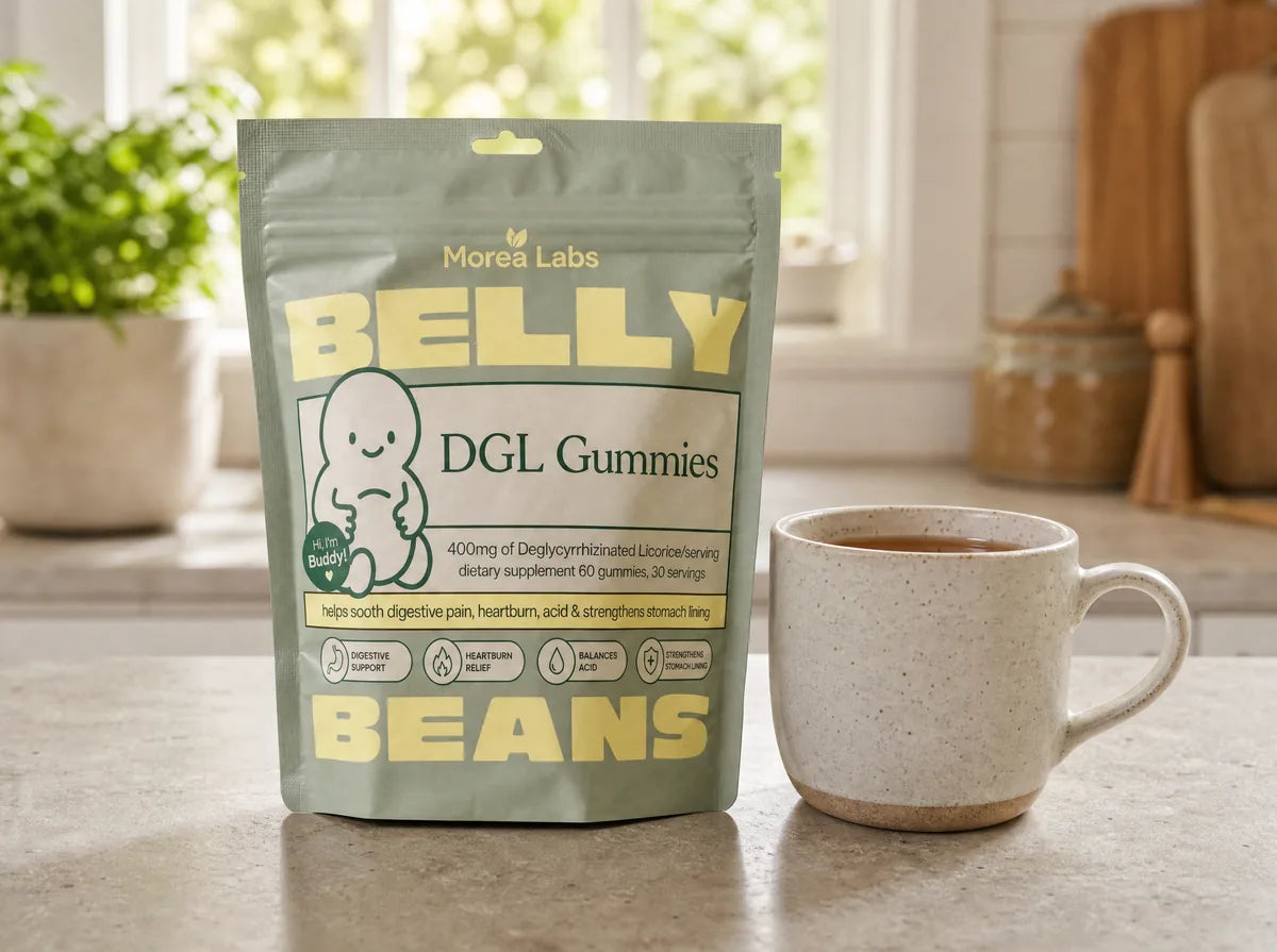 Belly Beans DGL gummies pouch on a kitchen counter beside a mug of tea
