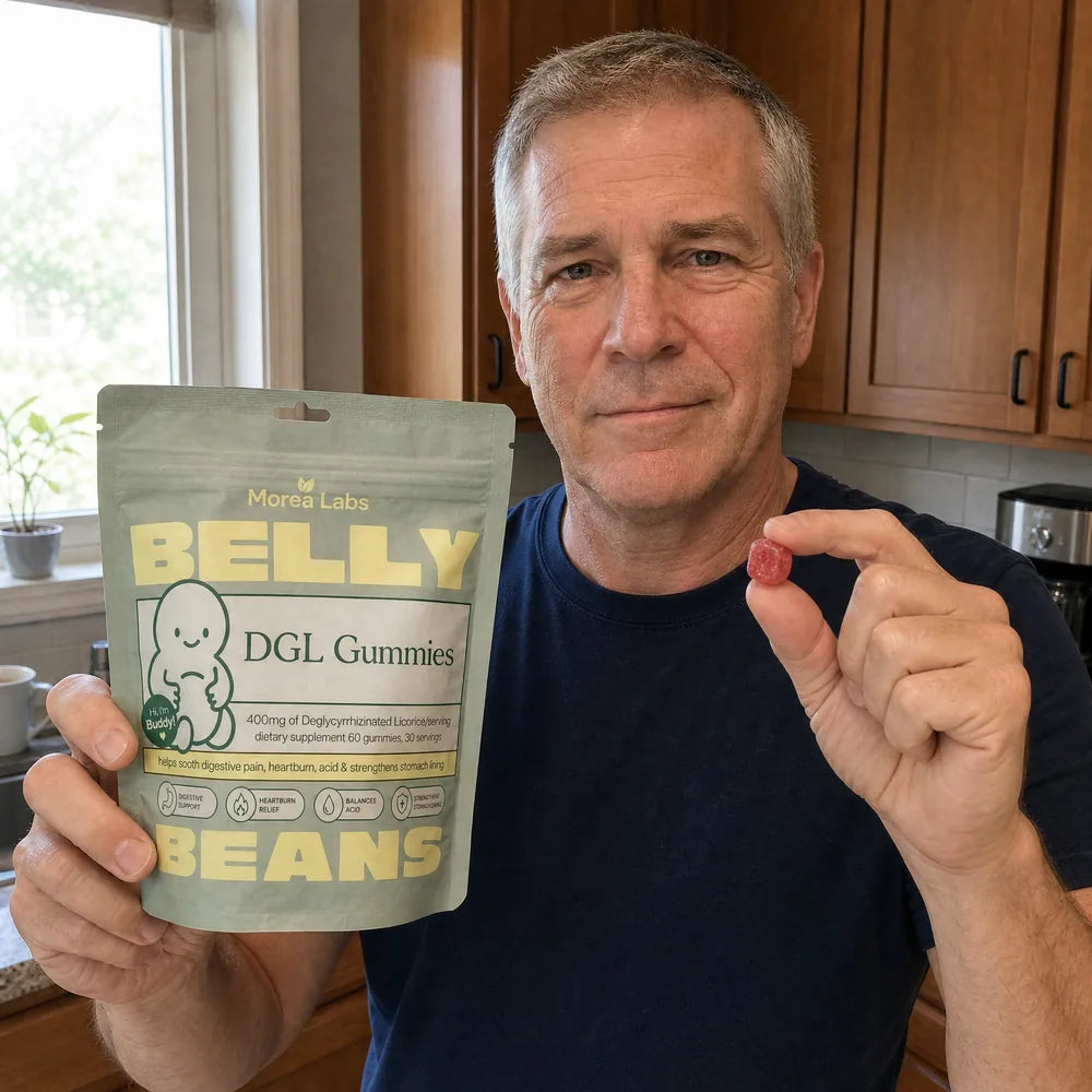 Man in his fifties holding Belly Beans DGL gummies and a single berry gummy
