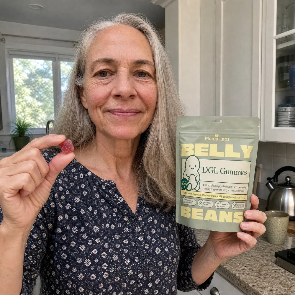 Woman in her sixties holding Belly Beans DGL gummies and a single berry gummy