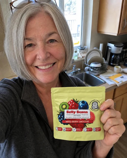 Customer holding a Belly Beans pouch in her kitchen