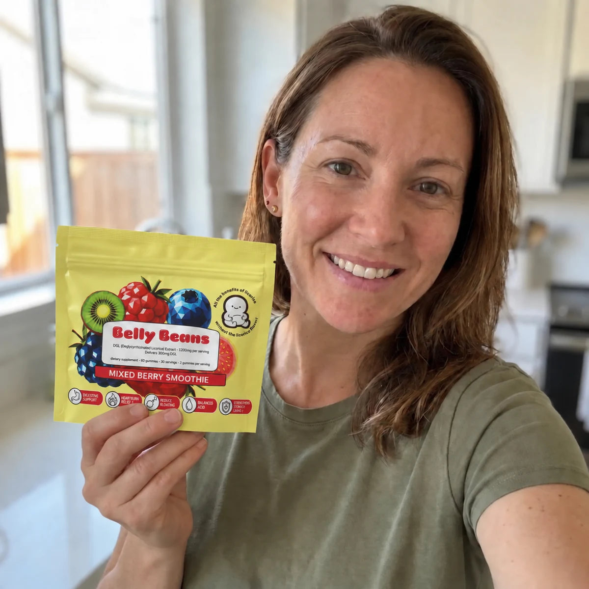 Woman holding Belly Beans in the new yellow packaging