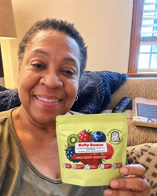 Customer holding a Belly Beans pouch on her couch