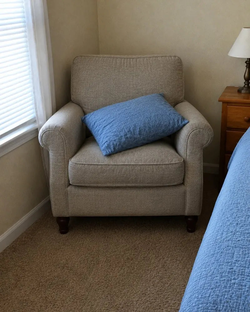 One pillow sitting on the bedroom armchair